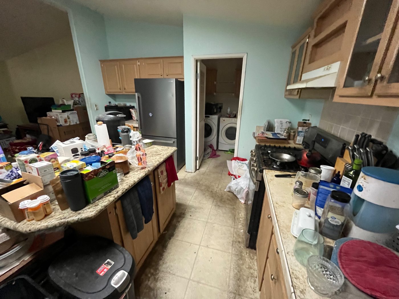 Cluttered mobile home kitchen packed with belongings, purchased as-is by Infinite Legacy Property Solutions