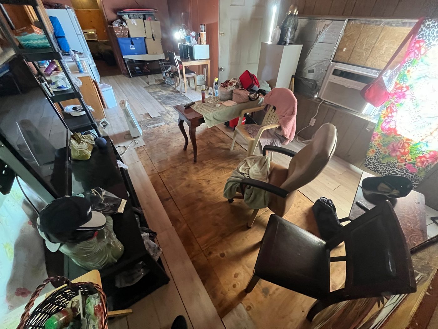 Cluttered storage room full of furniture and boxes, purchased as-is by Infinite Legacy Property Solutions